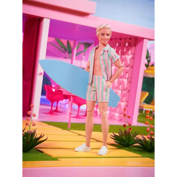 Barbie The Movie Ken Doll Wearing Pastel Pink and Green Striped Beach Matching Set with Surfboard and White SneakersBarbie The Movie Ken Doll Wearing Pastel Pink and Green Striped Beach Matching Set with Surfboard and White Sneakers