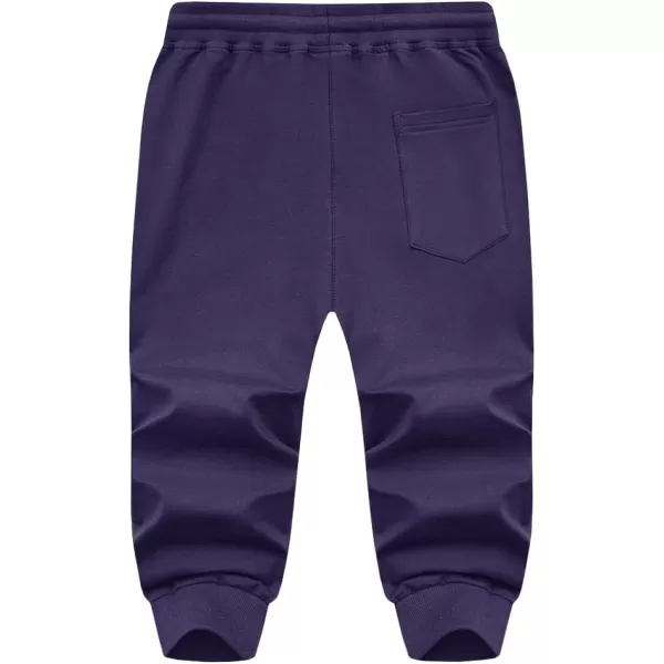 imageMAGNIVIT Mens 34 Jogger Capri Pants Workout Gym Below Knee Shorts Zipper Pockets Jogger Sweatpant Capris for MenMedium Purple