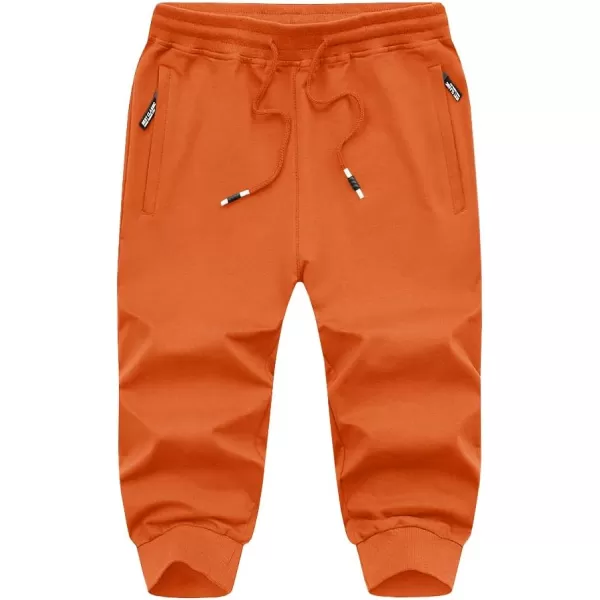 imageMAGNIVIT Mens 34 Jogger Capri Pants Workout Gym Below Knee Shorts Zipper Pockets Jogger Sweatpant Capris for MenOrange