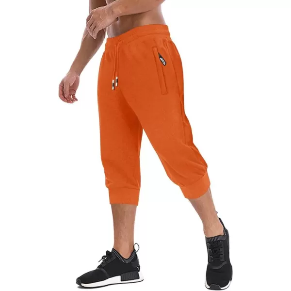 imageMAGNIVIT Mens 34 Jogger Capri Pants Workout Gym Below Knee Shorts Zipper Pockets Jogger Sweatpant Capris for MenOrange